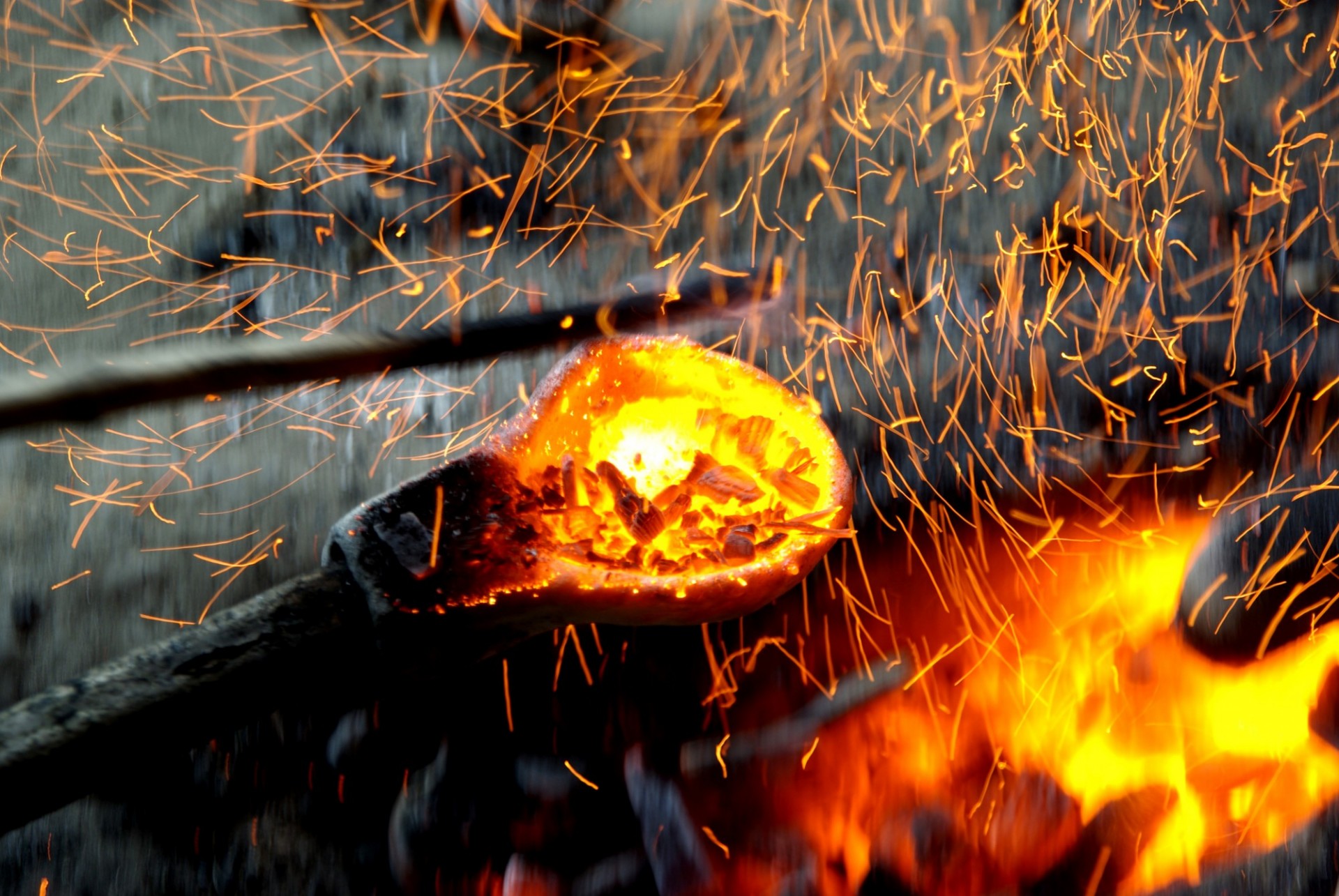 Metal handle in burning fire. 