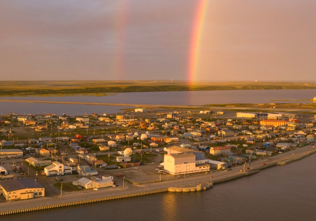 Image of rainbow over small coastal town in Alaska