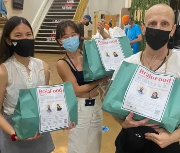 three people holding pages of people. 