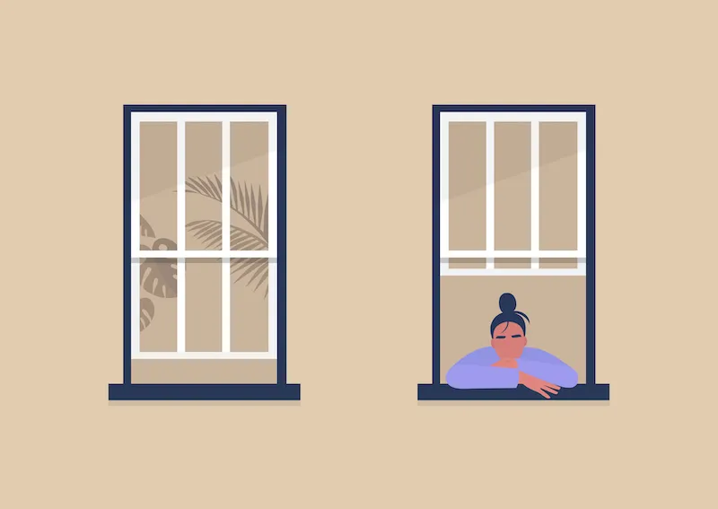 Image of a woman alone looking outside a window. 