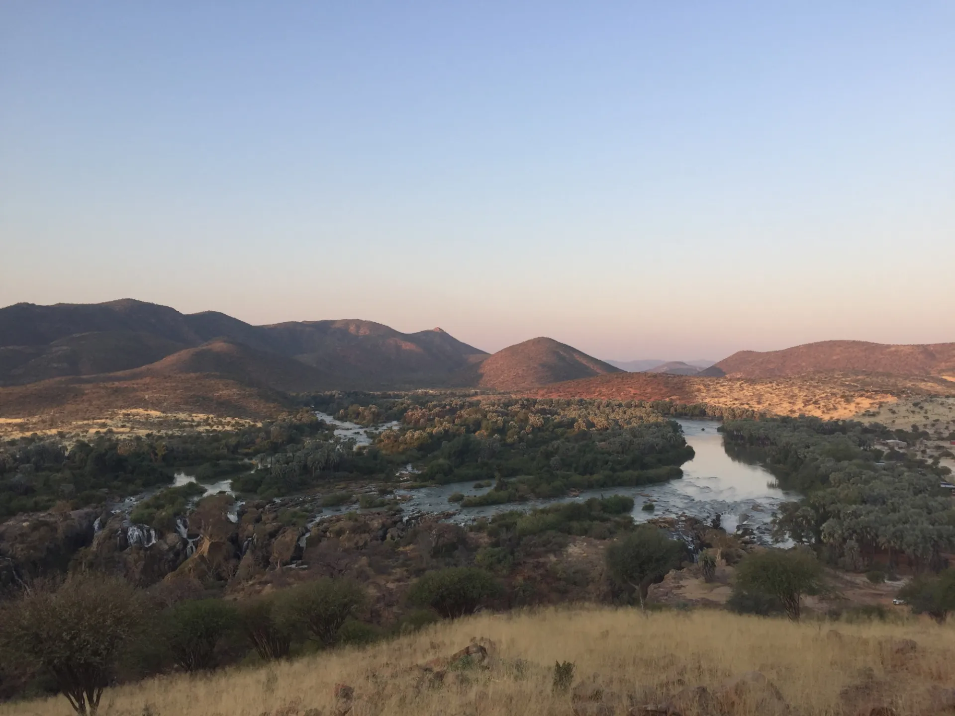 image of river running through grasslands and hills. 